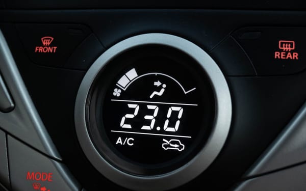 A close-up of a car's climate control display showing A/C