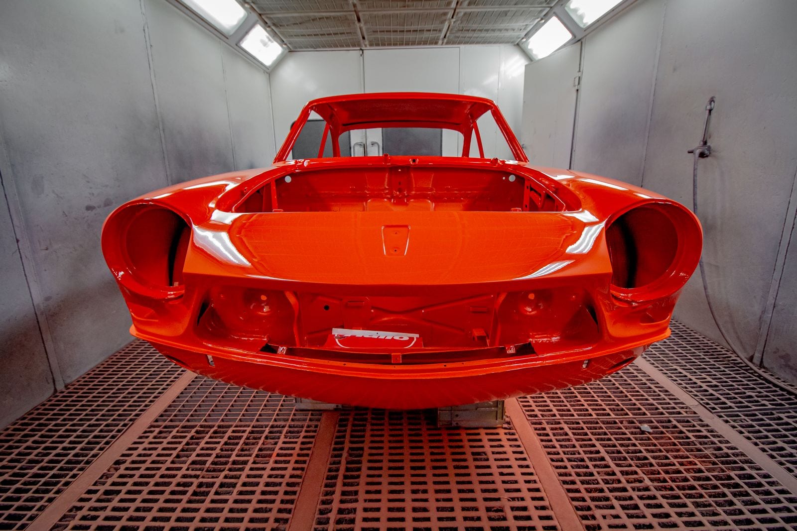 A painted vehicle body in a professional spray booth