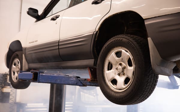 A car raised on a hydraulic lift in a repair shop