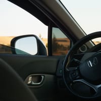 A car's steering wheel and driver's side window
