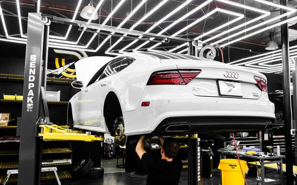 A car raised on a lift in a modern repair shop