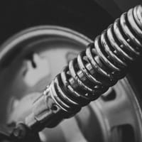 Close-up of a car's shock absorber and coil spring