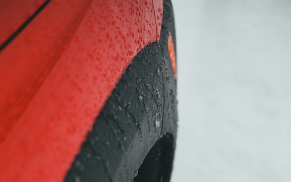 A car's winter tire on a snow-covered surface