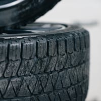 A stack of tires with winter tread patterns