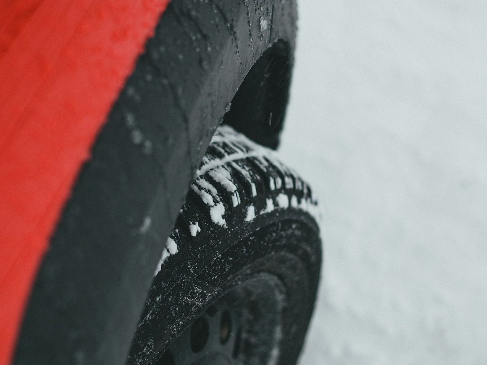 A close-up of a car's winter tire in the snow